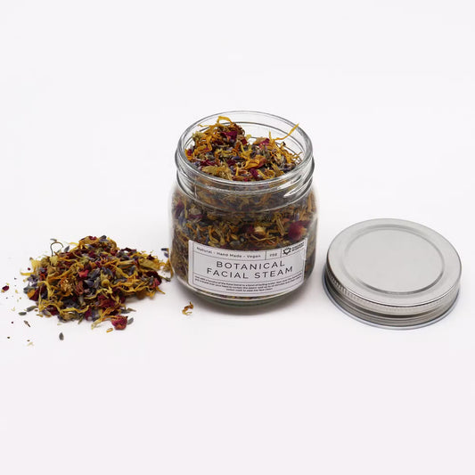 Jar of botanical facial steam with a label on a white background