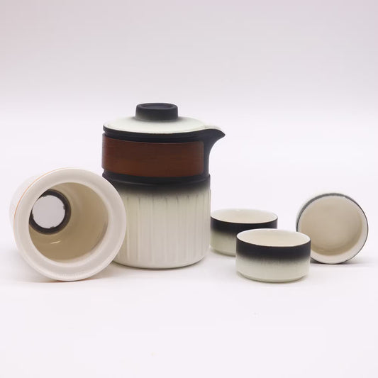 Ceramic tea set with a teapot and four cups on a white background