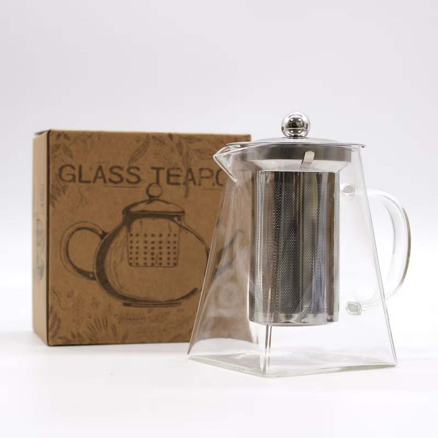 A clear glass teapot with a stainless steel mesh infuser and lid, shown next to its brown cardboard packaging box on a white background.