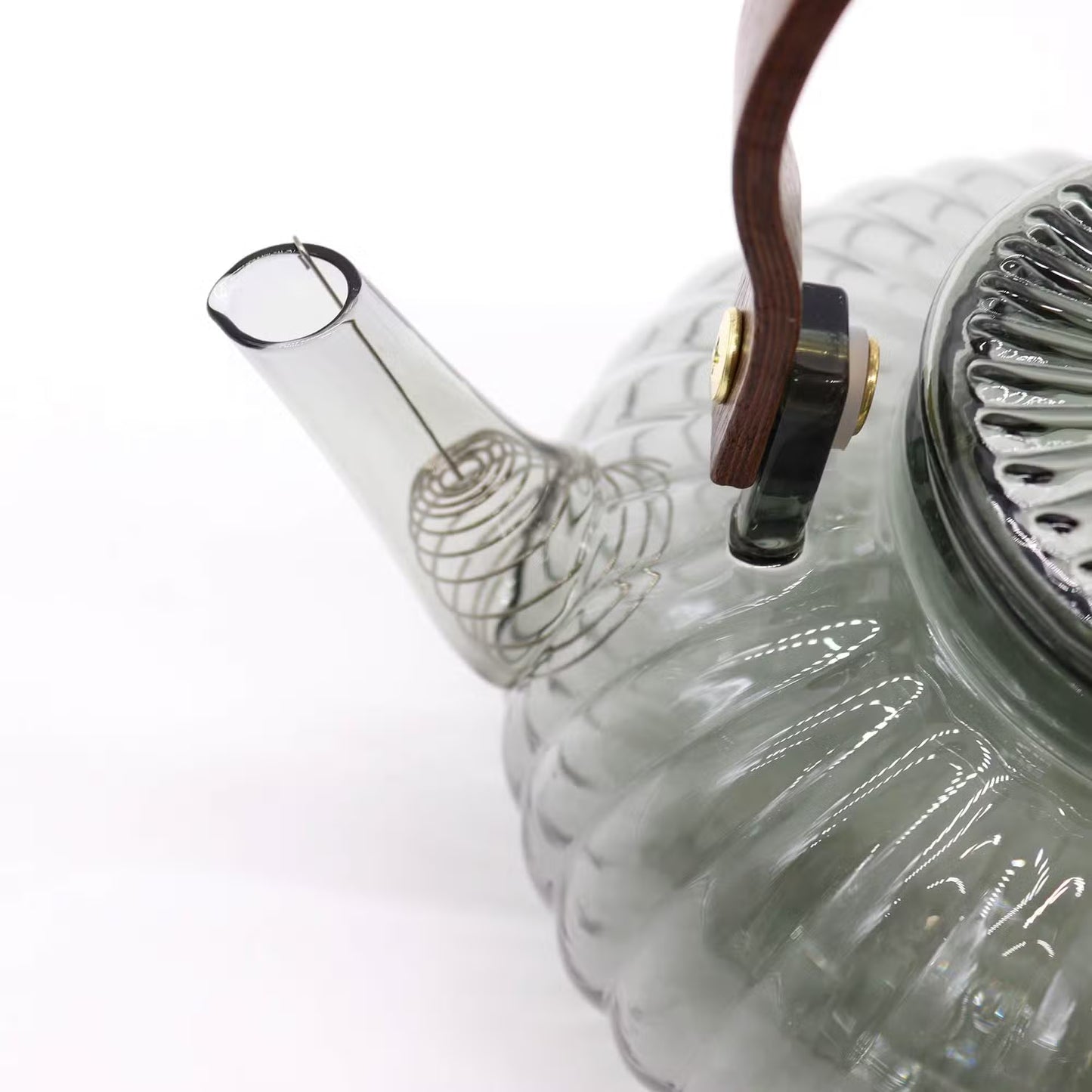 Glass teapot with a clear spout on a white background