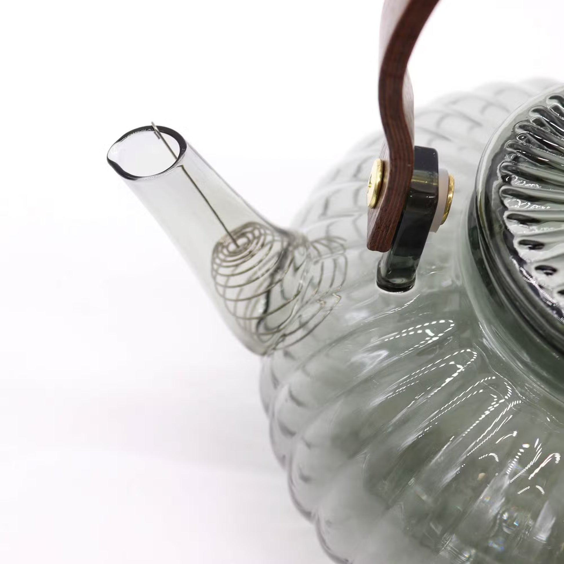 Glass teapot with a clear spout on a white background