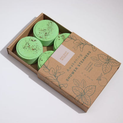 Box of green shower steamers with a cardboard box on a white background