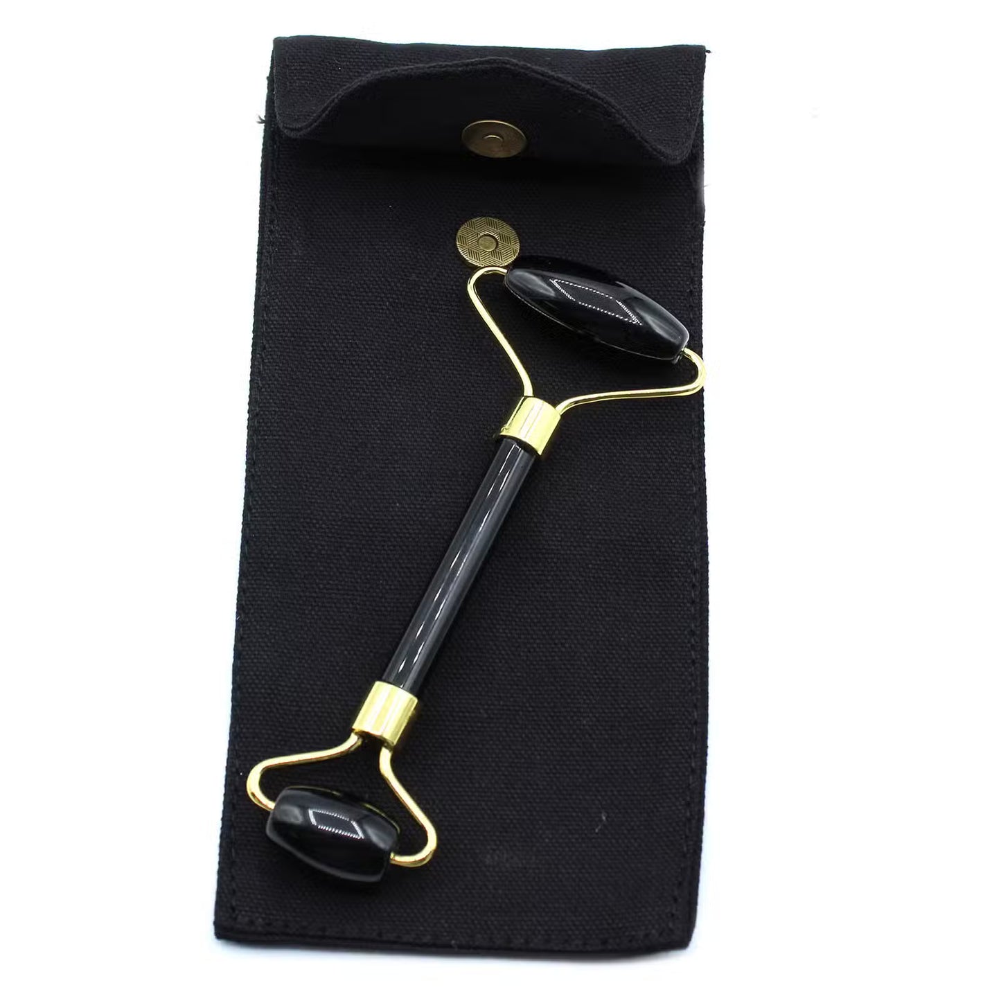Black and gold facial roller on a black pouch with a white background