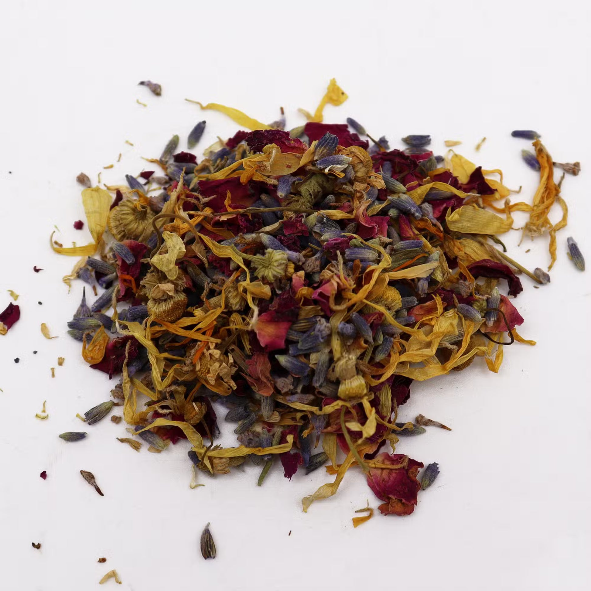 Pile of dried colorful flowers on a white background
