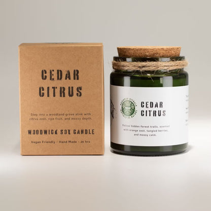 Woodwick Cedar Citrus candle with packaging on a light gray background
