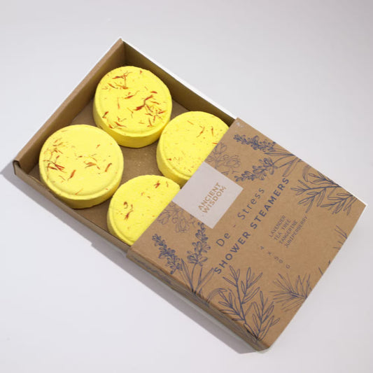 Box of yellow shower steamers with a brown cardboard box on a white background