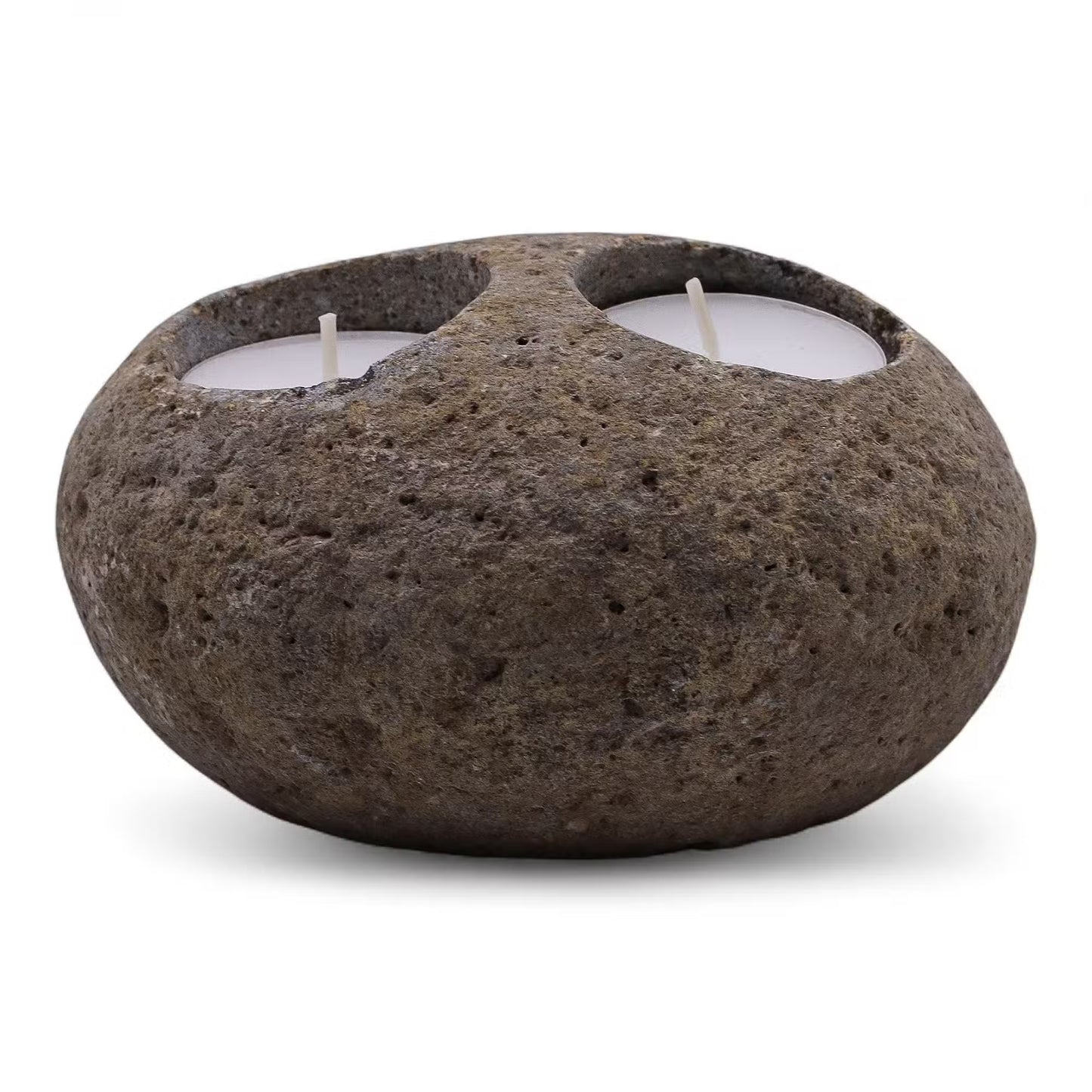Rustic stone candle holder with two lit candles on a white background