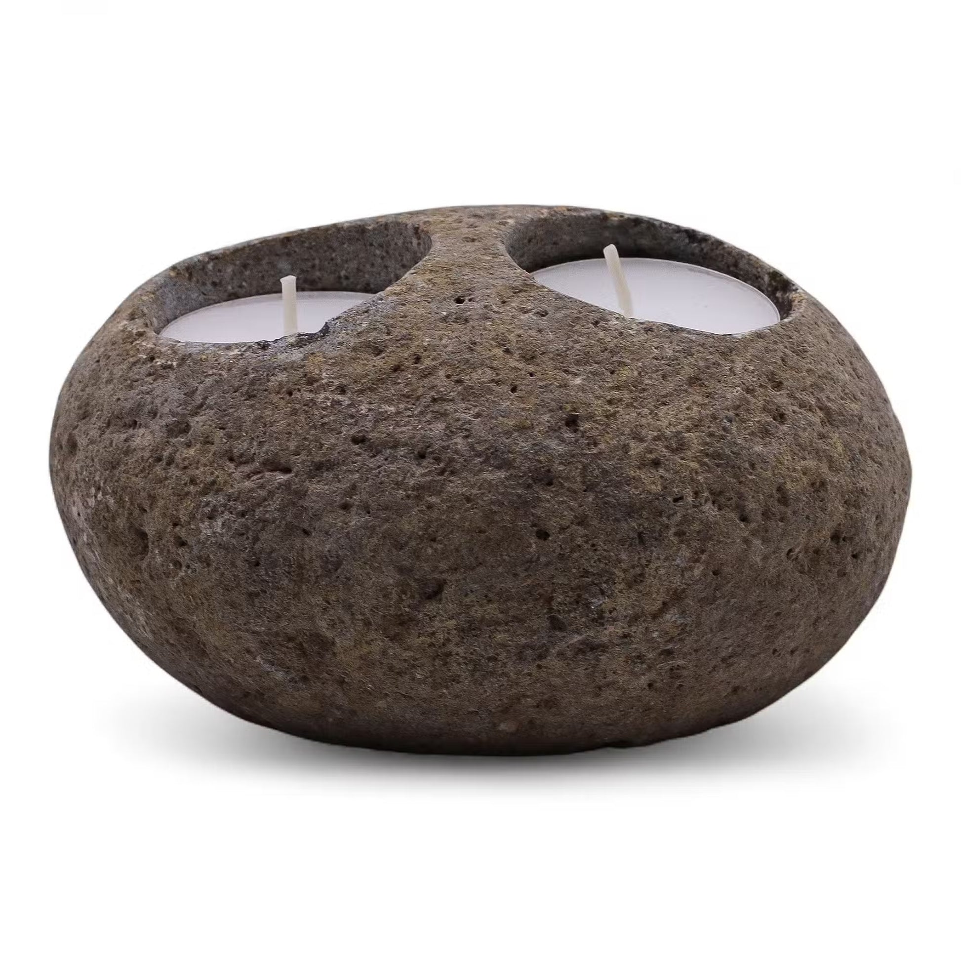 Rustic stone candle holder with two lit candles on a white background