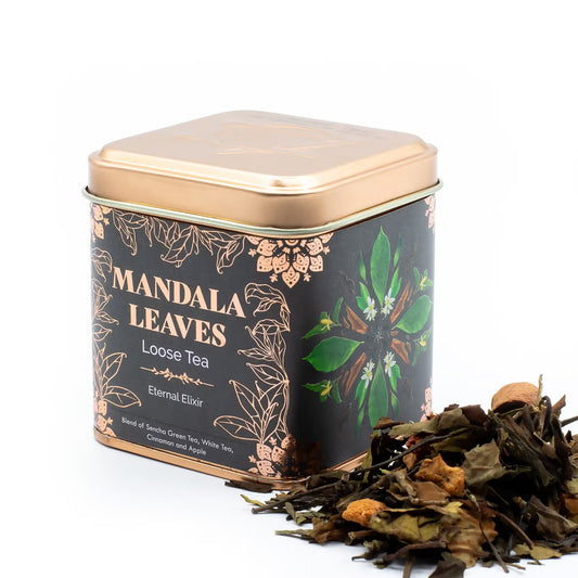 Tea tin labeled 'Mandala Leaves' with loose tea leaves on a white background