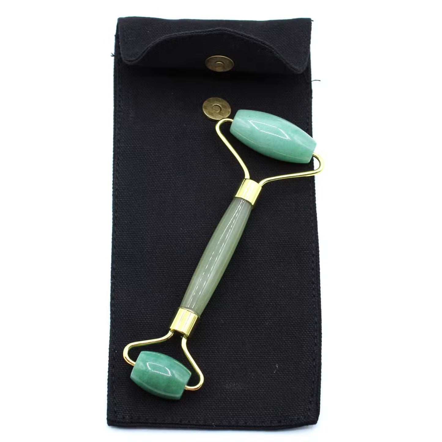 Green facial roller with gold accents on a black pouch