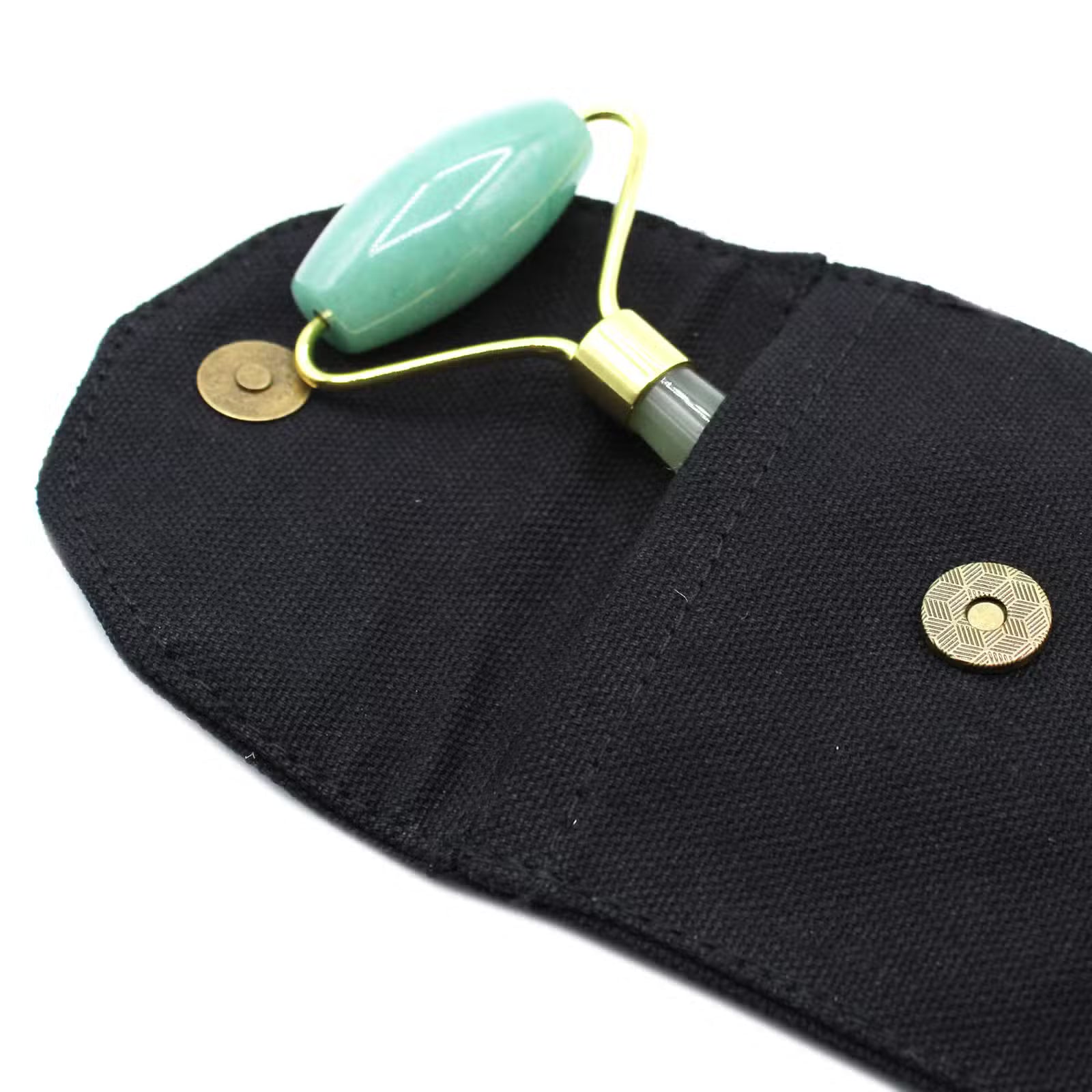  jade roller on a black pouch with gold accents