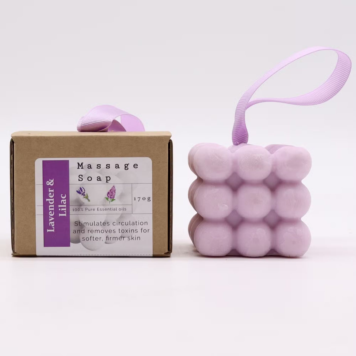 Lavender massage soap bar with packaging and a lavender-colored ball-shaped product on a white background