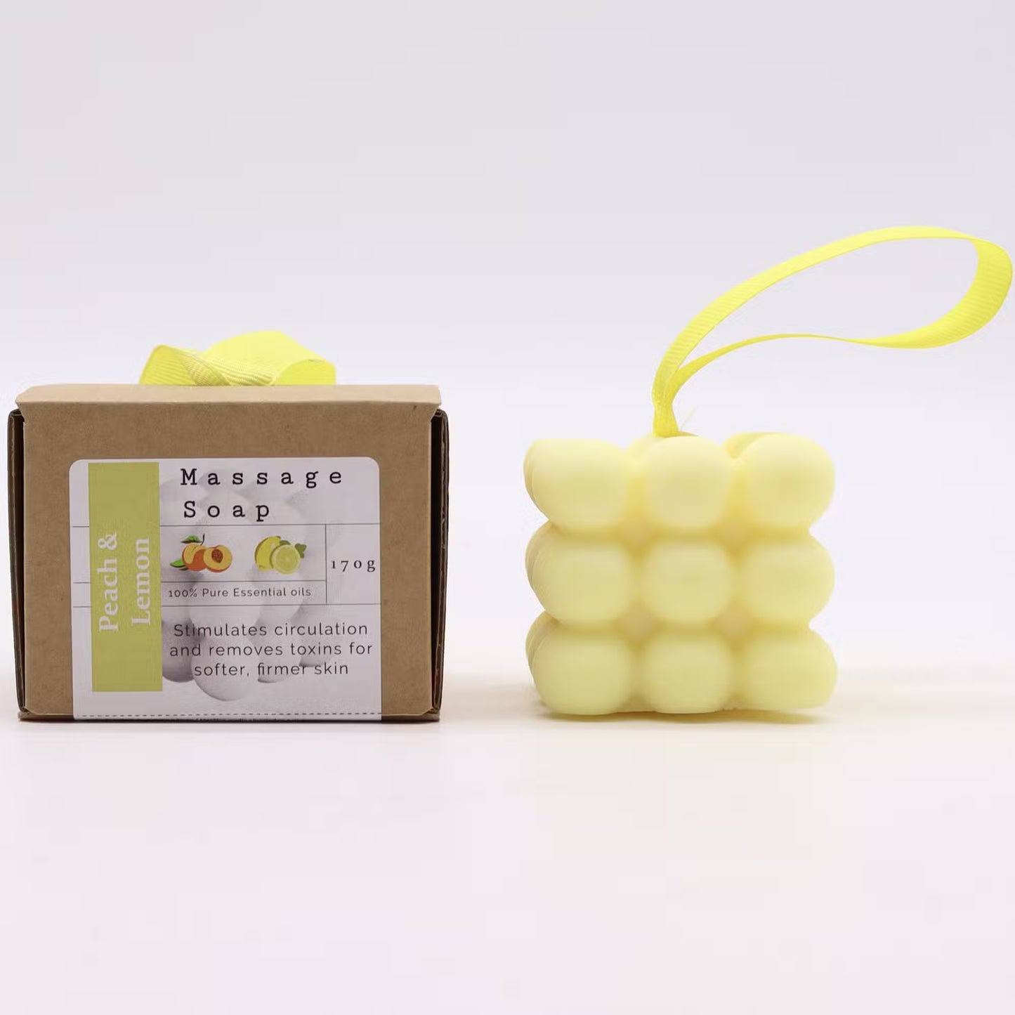 Massage soap with packaging and a yellow massage ball on a white background