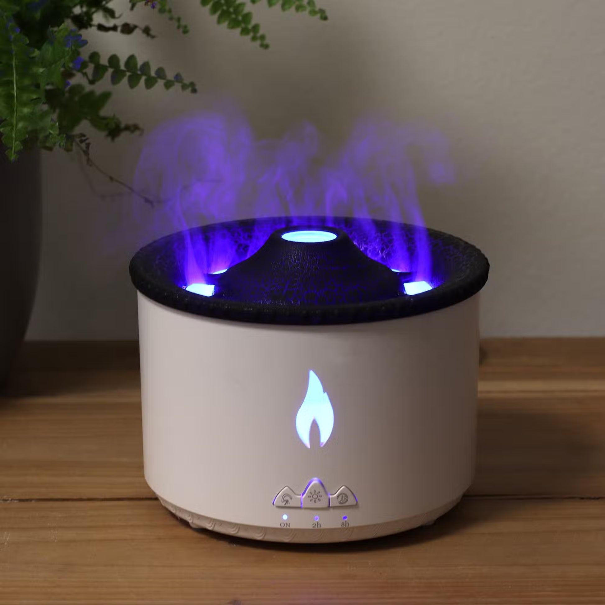 White and black diffuser with purple flames on a wooden surface