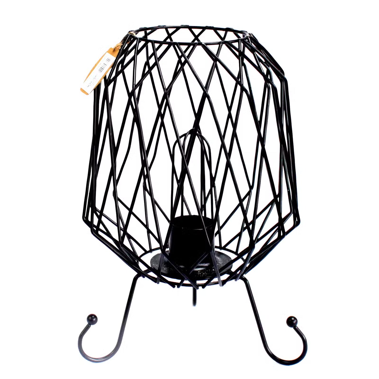 Black wire birdcage with a candle inside on a white background