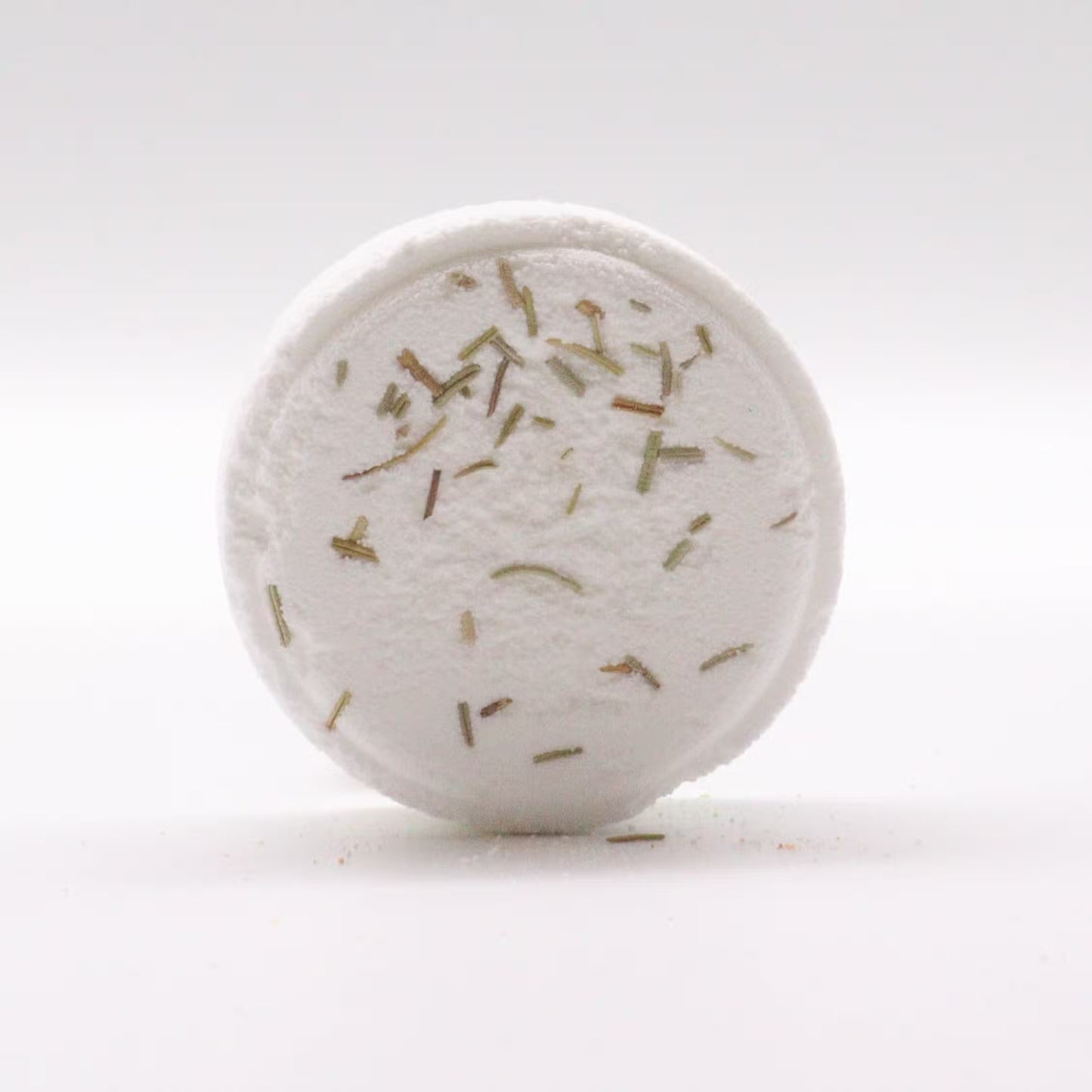 Round white object with specks on a white background