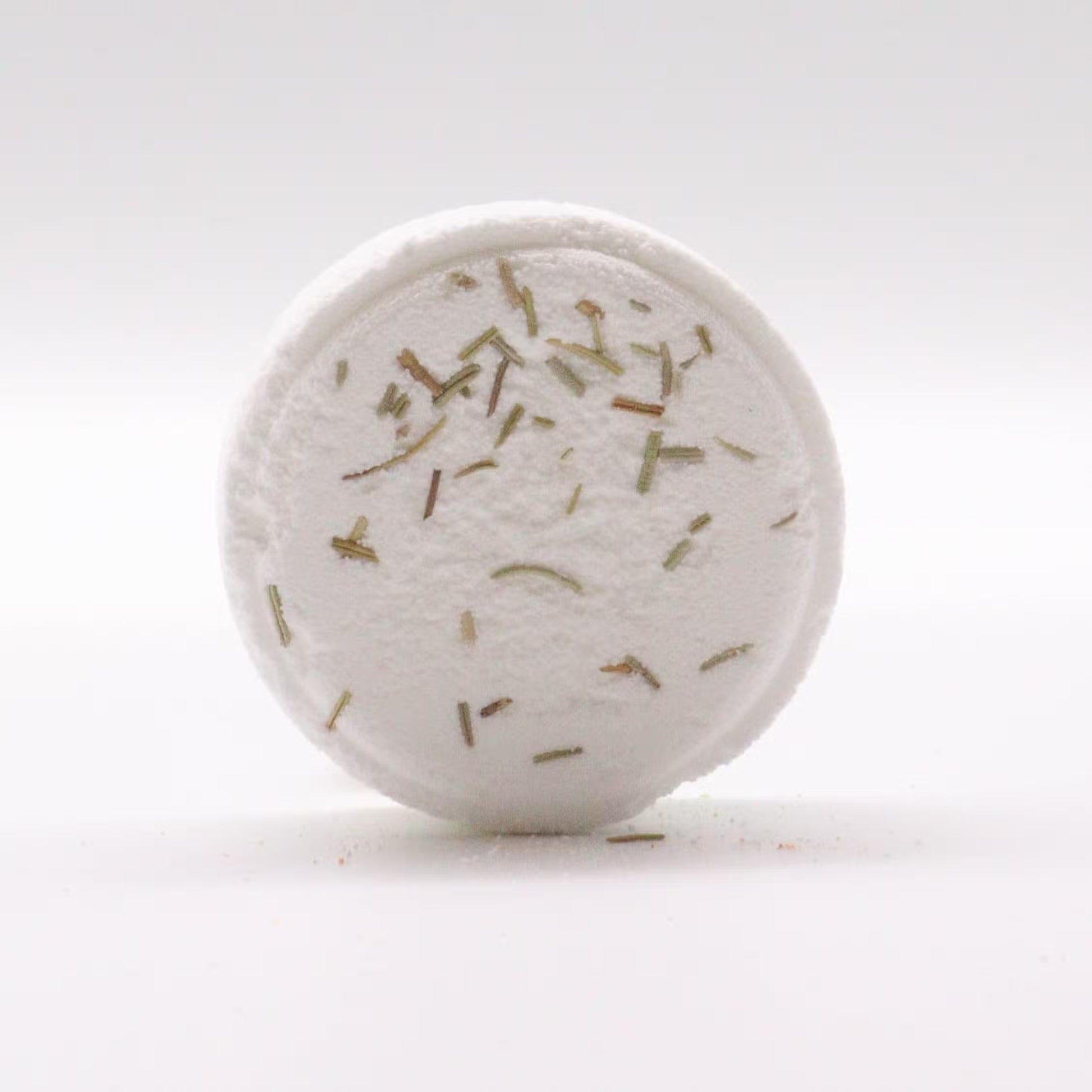 Round white object with specks on a white background
