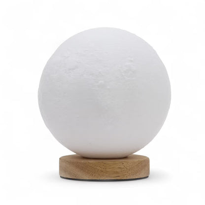 A 3D-effect textured white moon lamp on a round natural wood base, set against a plain white background.