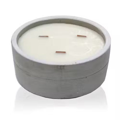 Candle in a concrete holder on a white background