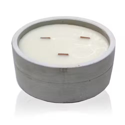Candle in a concrete holder on a white background