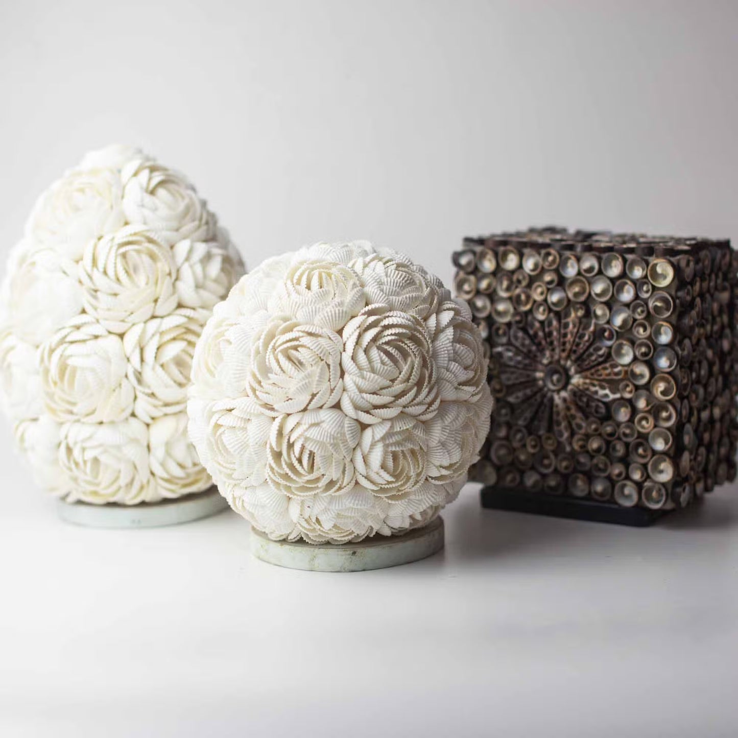 Decorative spherical objects with floral patterns on a white background