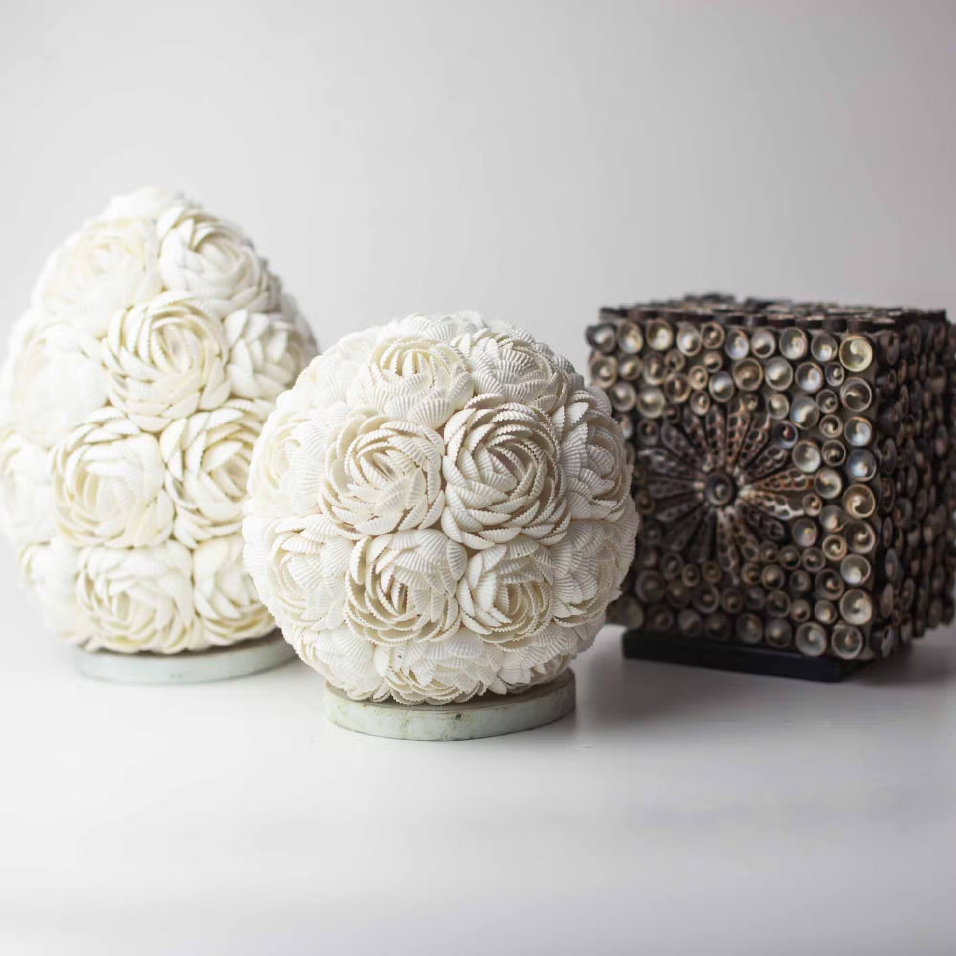 Decorative spherical objects with floral patterns on a white background