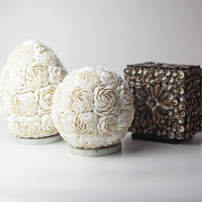 Decorative spherical objects with floral patterns on a white background