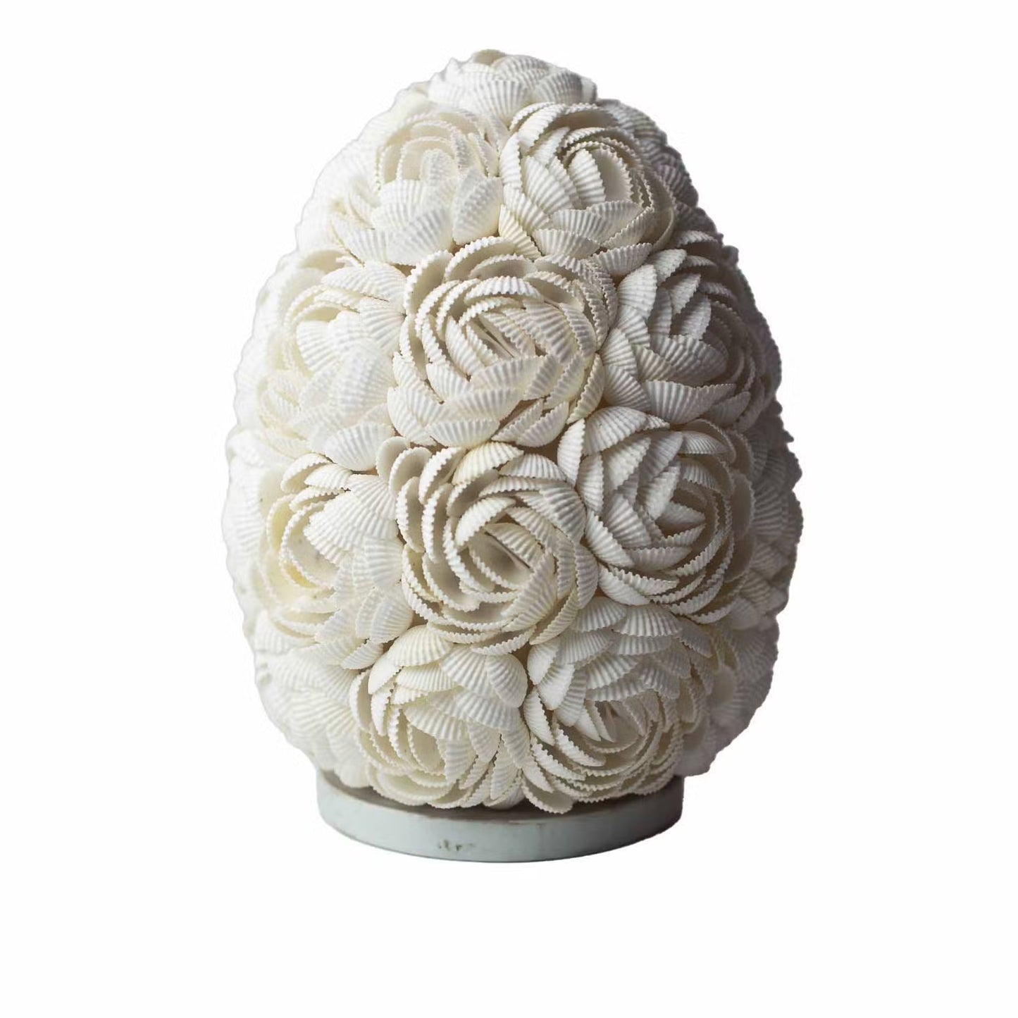 Decorative vase made of white seashells on a white background