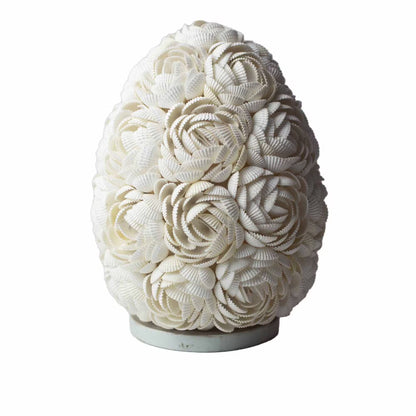 Decorative vase made of white seashells on a white background