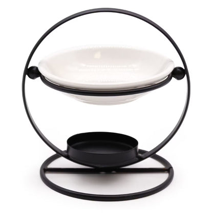 A black metal circular holder with a white ceramic dish resting on its upper ring and a small black tray on the base, photographed against a plain white background.