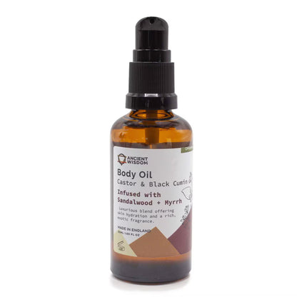 Brown glass bottle of body oil with a label on a white background