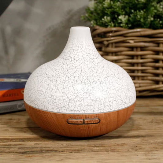 White textured diffuser with wooden base on a wooden surface
