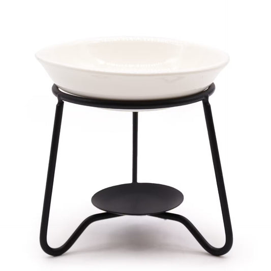 A white ceramic bowl with a beaded rim sits on a black metal stand featuring a curved tripod base and a circular shelf.