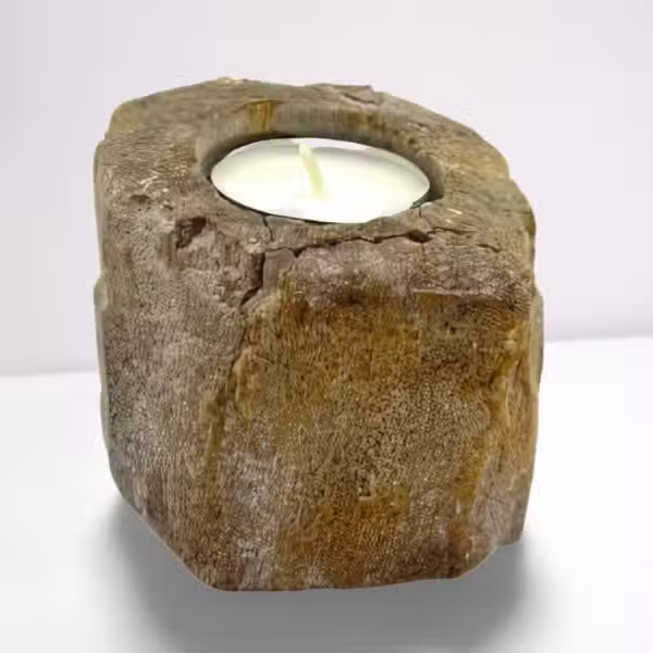 Candle holder made of natural stone with a white candle inside on a white background