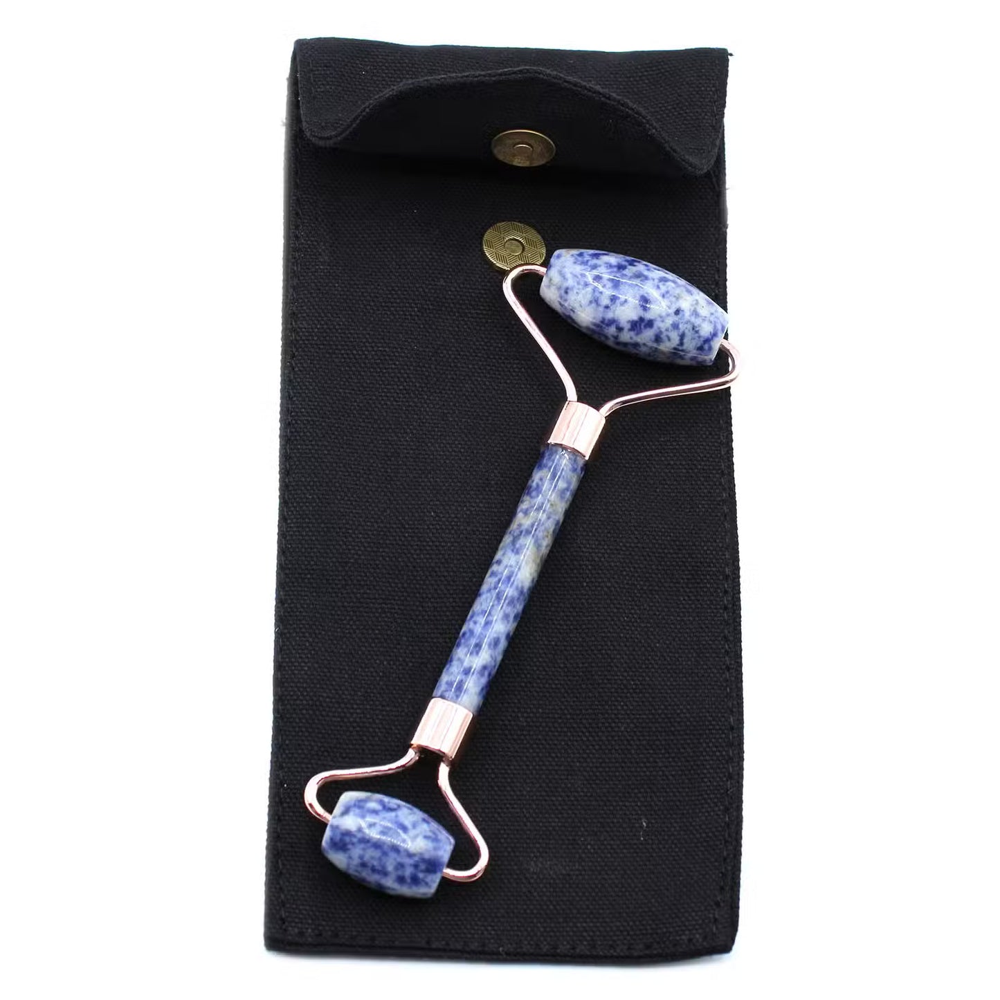 A double-ended jade roller massage tool with blue and white speckled stone beads and rose gold metal components, displayed on a black fabric pouch against a white background.