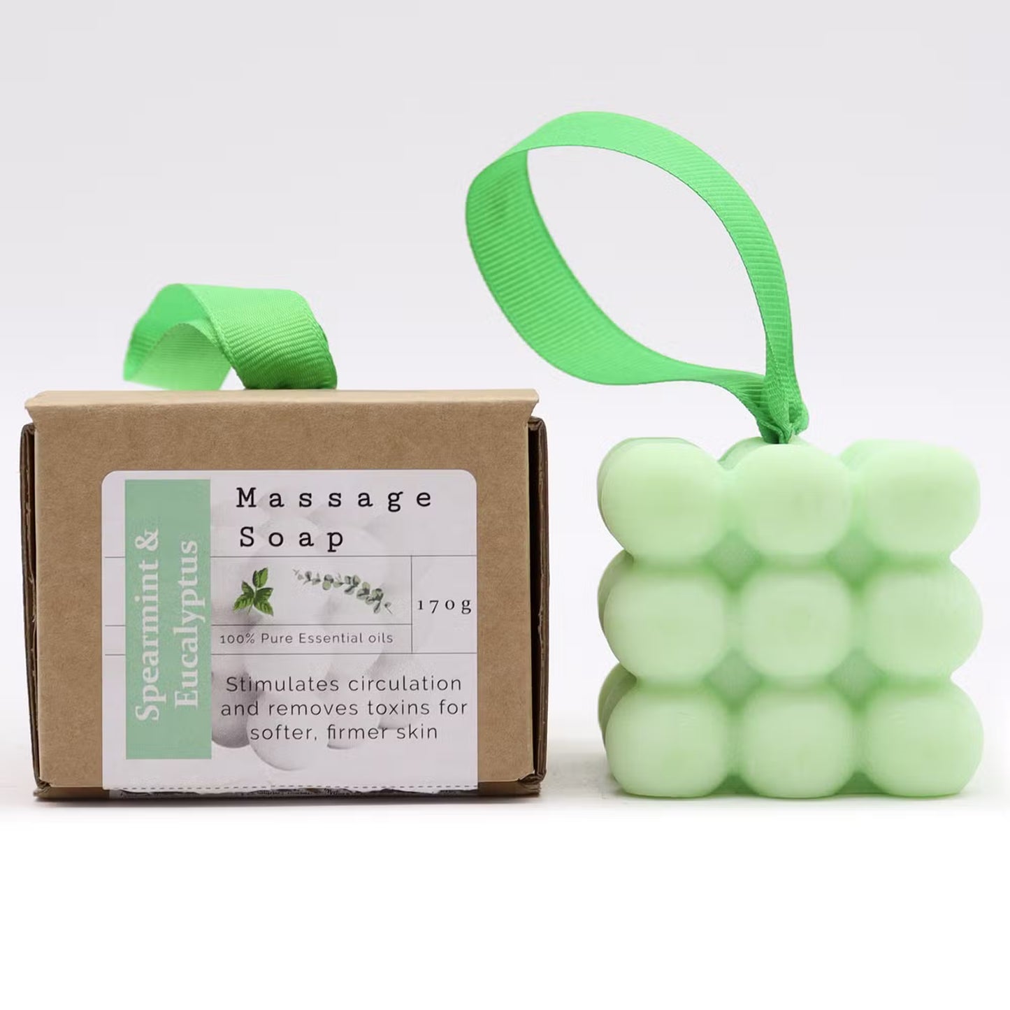 Massage soap bar with packaging and a green bubble-shaped soap on a white background