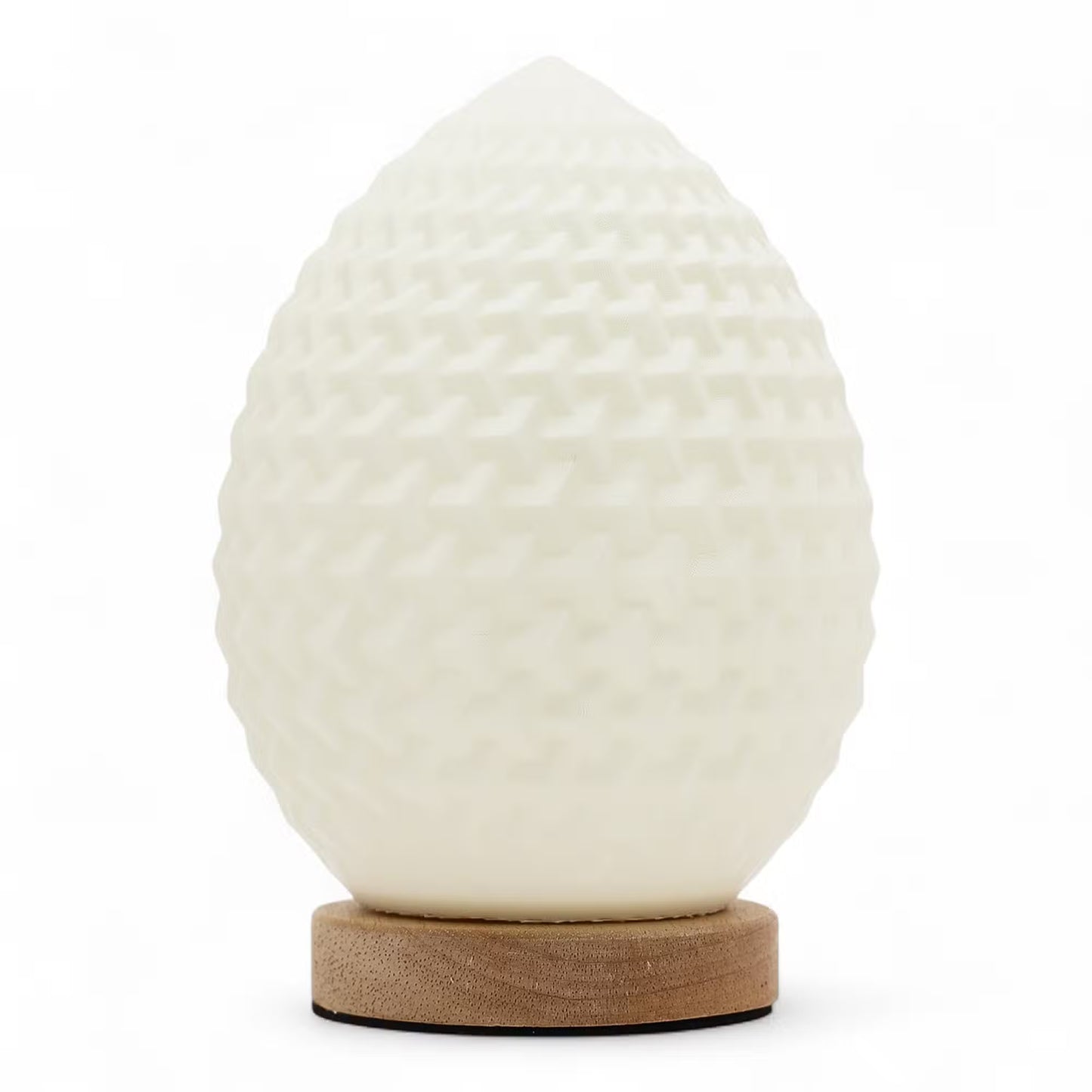A sculptural egg-shaped lamp with a textured, dimpled off-white surface, resting on a round natural wood base against a clean white background.