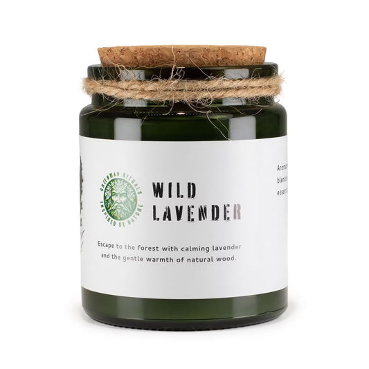 A jar candle and its kraft paper packaging box on a light gray background. The box is brown kraft paper with black text reading 'WILD LAVENDER' and 'WOODWICK SOY CANDLE'.
