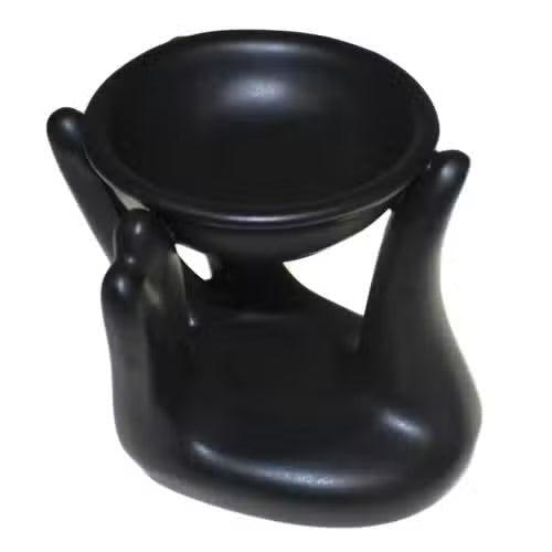 Black ceramic oil burner on a white background