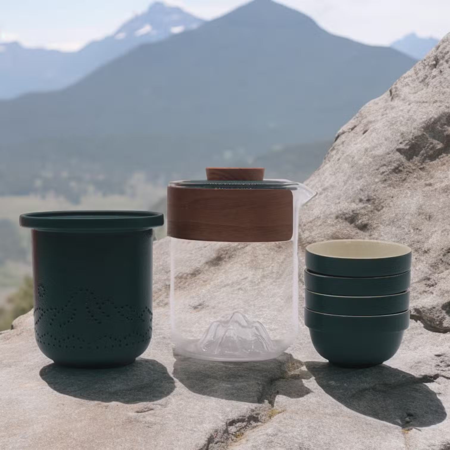 Ceramic cups and a glass jar with wooden lid on a rock with mountain background