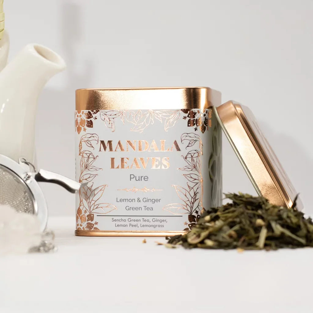 Mandala Leaves tea canister with gold lid on a white surface