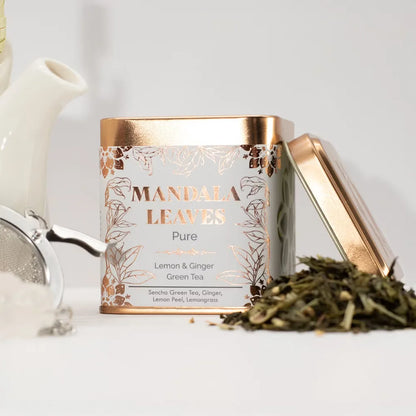 Mandala Leaves tea canister with gold lid on a white surface
